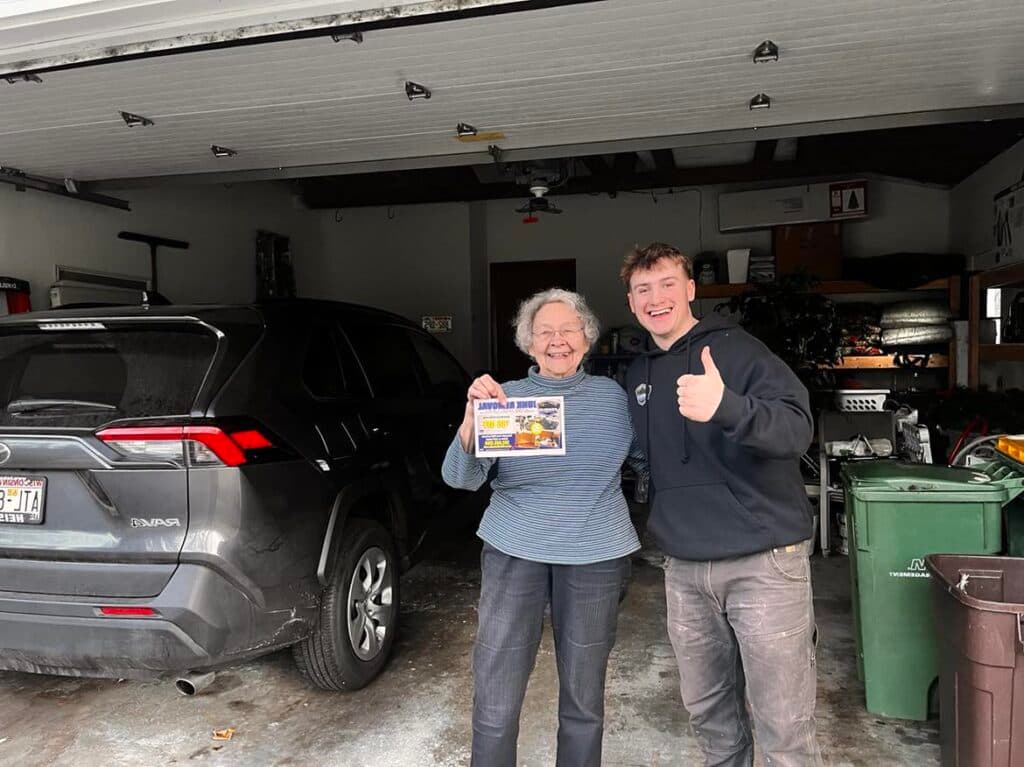 Junk Avengers team member with a happy customer after a junk removal job